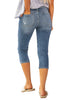 Back view of model wearing light blue below knee cropped skinny denim jeans
