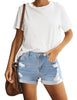 Model poses wearing light blue mid-waist rolled hem distressed denim shorts