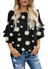Model wearing black trumpet sleeves keyhole-back daisy printed blouse