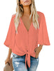 Model wearing peach V-neckline button-up tie-front top