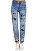 Front view of model wearing blue flower-print patch ripped rolled hem denim boyfriend jeans