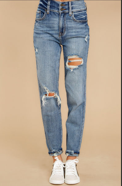 Front view of model wearing light blue double-button distressed denim jeans