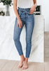 Front view of model wearing blue high-waist acid wash belted denim skinny jeans