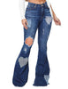 Front view of model wearing dark blue mid-waist ripped heart flared denim jeans