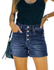 Front view of model wearing dark blue raw hem mid-waist distressed denim shorts