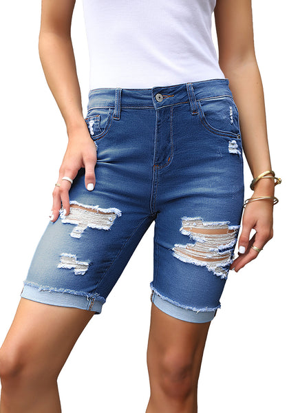 Front view of model wearing blue plus size mid-waist ripped denim bermuda shorts.