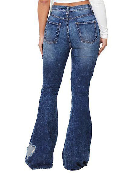 Back view of model wearing dark blue mid-waist ripped heart flared denim jeans