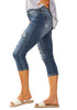 Side view of model wearing blue below knee cropped skinny denim jeans