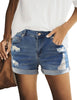 Front view of model wearing dark blue mid-waist rolled hem distressed denim shorts