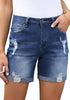 Front view of model wearing blue rolled hem mid-waist distressed denim shorts
