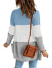 Back view of model wearing light blue colorblock front pockets button-up cable knit cardigan