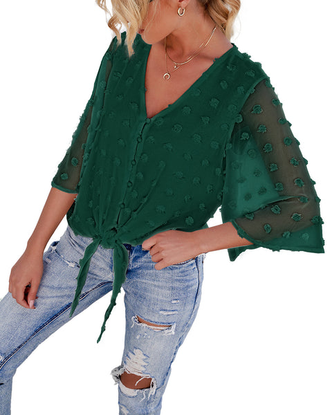 Angled view of model wearing dark green 3/4 sleeves pompom tie-front top