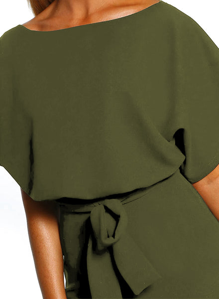 Close-up view of model wearing emerald green short sleeves keyhole-back belted romper