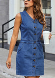 Angled shot of model in dark blue raw hem sleeveless button-down denim dress