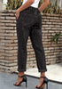 Angled shot of model wearing black drawstring-waist cuffed ripped boyfriend jeans
