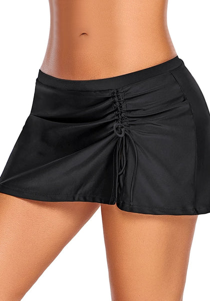 Angled shot of model wearing black elastic waist slit side-drawstring skirtini bottom