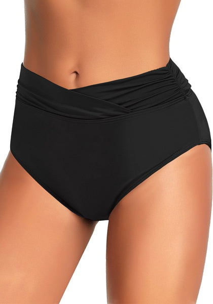 Angled shot of model wearing black surplice-waist ruched bikini bottom