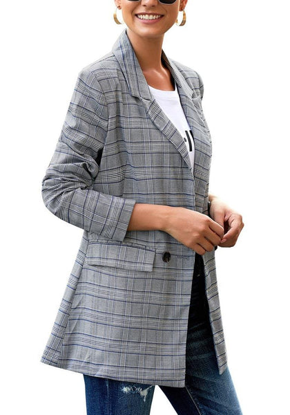 Angled shot of model wearing blue double-breasted flap pockets plaid lapel blazer