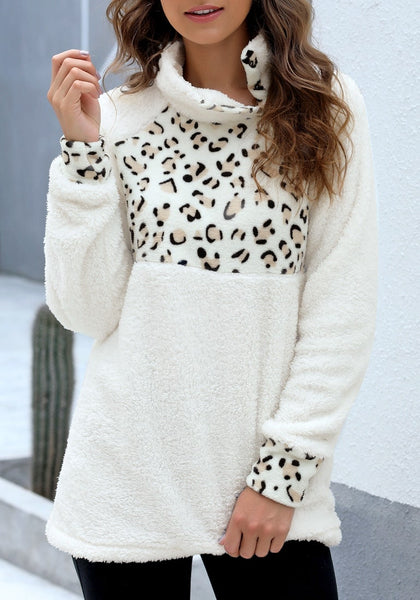 Angled shot of model wearing white oblique stand collar leopard fleece pullover