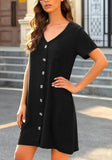 Angled view of model wearing black V-neck button down short sleeve mini dress