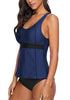 Angled view of model wearing navy blue racerback tankini set