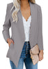 Angled shot of model in grey open-front side pockets blazer
