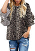 Angled shot of model wearing black trumpet sleeves keyhole-back leopard blouse
