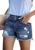 Angled shot of model wearing dark blue double raw hem ripped jean shorts