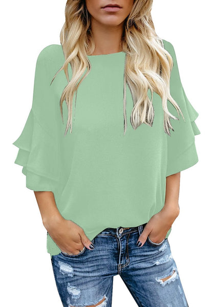 Model wearing mint green trumpet sleeves keyhole-back blouse