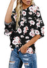 Angled side shot of model in black trumpet sleeves keyhole-back printed blouse