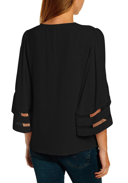Back view of model in black 34 bell mesh panel sleeves strappy V-neckline loose top