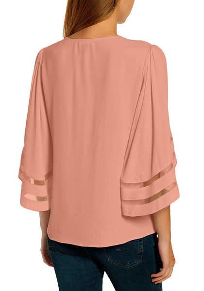 Back view of model in pink 34 bell mesh panel sleeves strappy V-neckline loose top