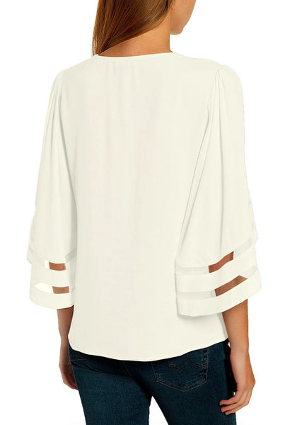 Back view of model in white 34 bell mesh panel sleeves strappy V-neckline loose top