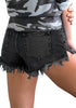 Back view of model wearing black frayed raw hem distressed denim shorts