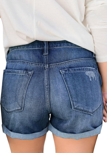 Back view of model wearing blue roll-over hem button-up ripped denim shorts