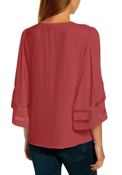 Back view of model wearing coral pink 34 bell mesh panel sleeves strappy V-neckline loose top