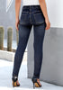 Back view of model wearing dark blue high-rise ripped buttoned denim jeans