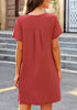 Back view of model wearing dark coral pink V-neck button down short sleeve mini dress
