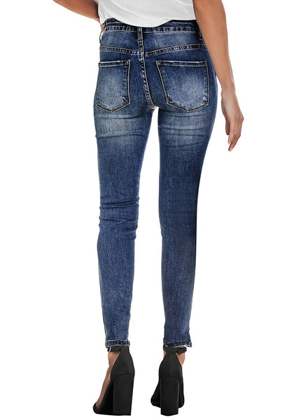 Back view of model wearing deep blue high-rise ripped skinny denim jeans