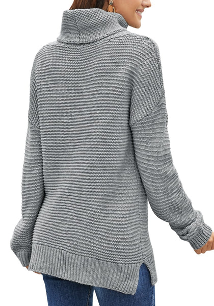 Back view of model wearing grey side slit turtleneck textured knit sweater