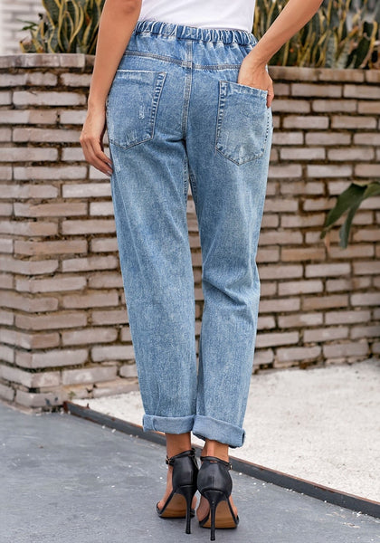 Back view of model wearing light blue drawstring-waist cuffed ripped boyfriend jeans