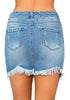 Back view of model wearing light blue frayed hem washed denim mini skirt