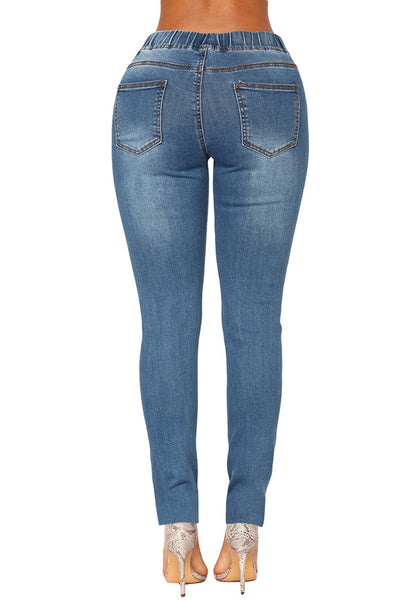 Back view of model wearing medium blue drawstring-waist washout ripped skinny jeans