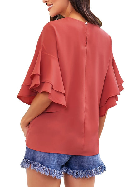 Back view of model wearing rust red trumpet sleeves keyhole-back blouse