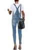 Back view of modell wearing light blue ripped skinny jeans denim bib overall