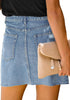 Back view of odel wearing blue raw hem distressed denim mini skirt