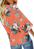 Back view of model wearing coral V-neckline button-up tie-front floral top
