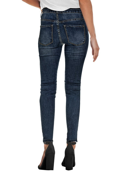 Back view of model wearing dark blue high-rise ripped skinny denim jeans