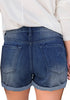 Back view of model wearing dark blue roll-over ripped washed denim shorts
