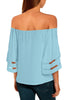 Back view of model wearing light blue 3-4 bell mesh panel sleeves tie-front off-shoulder top